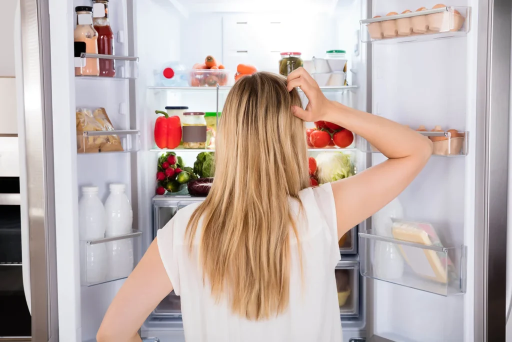woman infront of fridge with excessive noise